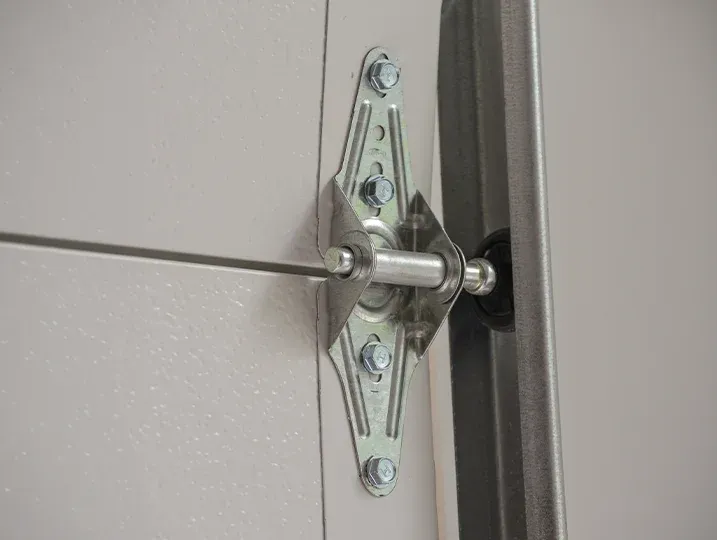 Professional technician performing Garage Door Hinge Repair in South Florida.